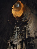 A caver climbs out of a vertical shaft through Green's Well