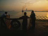 Riders on the Staten Island Ferry look out at the Manhattan skyline