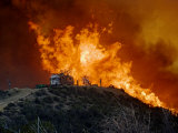 Flames surge up a hillside near the Pacific Coast Highway in Malibu