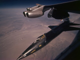 An X-15 rocket plane drops free of a B-52