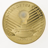 An LED bulb that lights up embedded in a coin from Niue Island
