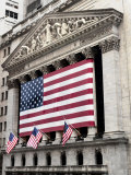 The facade of the New York Stock Exchange draped in the American Flag