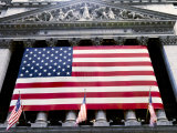 The facade of the New York Stock Exchange draped in the American Flag