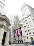The facade of the New York Stock Exchange draped in the American Flag