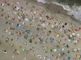 Aerial view of wall-to-wall seaside sunbathers