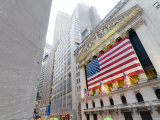 The facade of the New York Stock Exchange draped in the American Flag