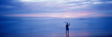 Silhouette of a Man Carrying a Surfboard over His Head on the Beach  Costa Rica