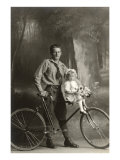 Standing Bicyclist with Little Girl on Handlebars