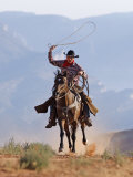 Cowboy Running with Rope Lassoo in Hand  Flitner Ranch  Shell  Wyoming  USA