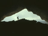 Potholer Silhouetted at Exit to Underground Cave System  Huesco  Spain