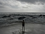 Child Standing at the Edge of Tide