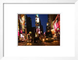 People and Cars at Times Square at Night with Illuminated Lights and Signs in New York City