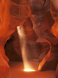 Sunbeam Illuminates Sandy Floor and Sandstone Walls of a Slot Canyon  Antelope Canyon  Page