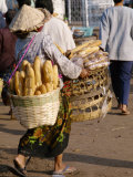 Woman Carrying Baskets of French Bread  Talaat Sao Market in Vientiane  Laos  Southeast Asia
