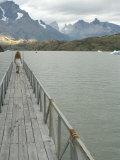 Blonde Woman Walks to the End of Dock on Lago Grey  Torres Del Paine  Chile  South America