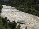 Backpacker Crosses Bridge over Urubamba River  on the Inca Trail  Peru  South America