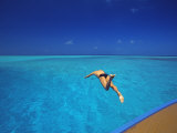 Man Jumping into Tropical Sea from Deck  Maldives  Indian Ocean