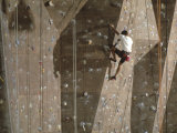 Man Wall Climbing Indoors with Equipment