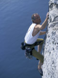 Male Rock Climber Reaching for a Grip