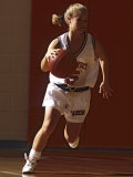 Female High School Basketball Player in Action During a Game