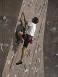Man Wall Climbing Indoors with Equipment