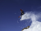 Male Snowboarder Flying Through the Air