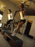 Women Performing Step Exercise with Handweights in Gym
