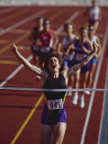Female Runner Victorious at the Finish Line in a Track Race