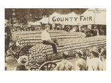 Man Sitting on Giant Ear of Corn