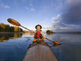 Kayaker on Lower Stillwater Lake near Whitefish  Montana  USA