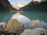 Rocky Mountains and boulders reflected in Lake Louise  Banff National Park  Alberta  Canada