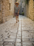 Woman walking in narrow cobblestone alley  Stari Grad Town  Hvar Island  Dalmatia  Croatia
