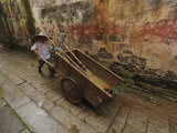Chinese man pushing cart  Hong Cun Village  Yi County  China
