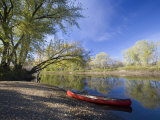 A Canoe rests on the banks of he Connecticut River in Maidstone  Vermont  USA
