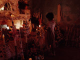 Child Lighting Candles on the Day of the Dead as Celebrations Begin