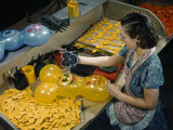 Worker Stamps Faces on Rubber Mickey Mouse Balloons