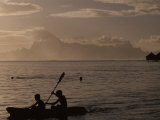 Young Kayakers and Swimmers at Dusk Moorea Island in the Distance