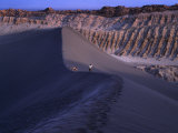 Hikers Walking Along the Top Ridge of a Large Dune