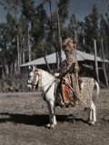 Minister of War Rides a Mule While Modeling His Lion Headdress