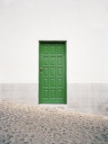 Cobblestone Street Runs Past a Green Door Found in San Sebastian