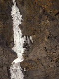 Man Ice Climbing on a Frozen Waterfall