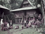 Polygamous Moro Chief Sits with His Family Outside His House