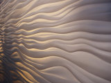 Lighting Illiuminates an Architectural Display of Waves in a Wall