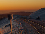Railroad Tracks at Sunset in an Icy Mountain Landscape