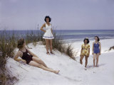 Four Women Walk and Recline on a Beach Along the Gulf of Mexico
