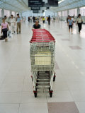 Chinese Man Pushes Shopping Carts in a Large Shopping Center