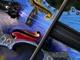 Bow Draws a Melody from the Strings of a Colorful  Painted Violin