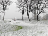 Lone Figure Walking in Copenhagen Fortress During Snowstorm