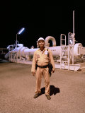 Worker in Front of a Giant Natural Gas and Oil Pipeline in Myanmar