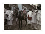 Four Men with Rifles Stand Beside a Decorated Mule